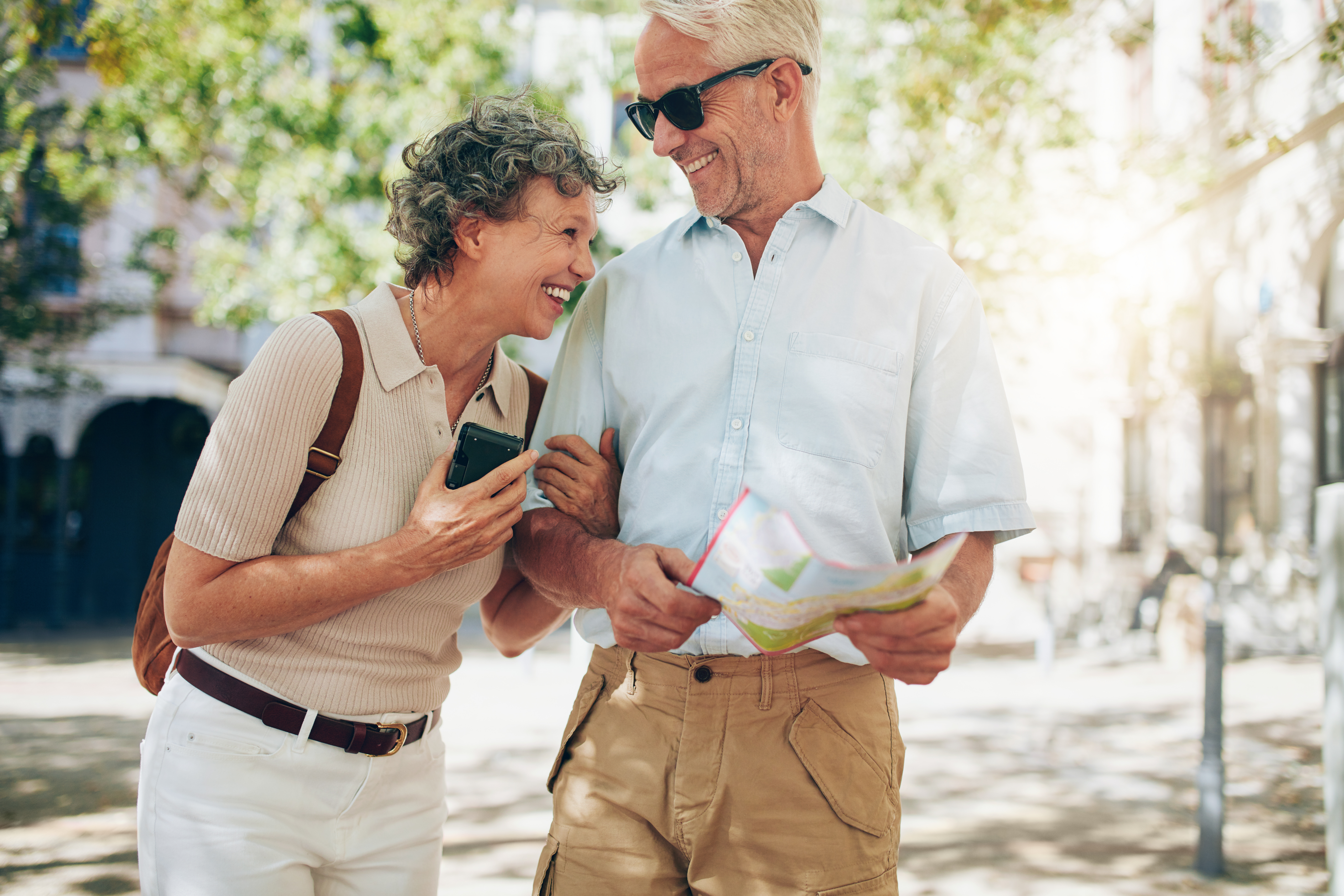 An older couple exploring together with a map